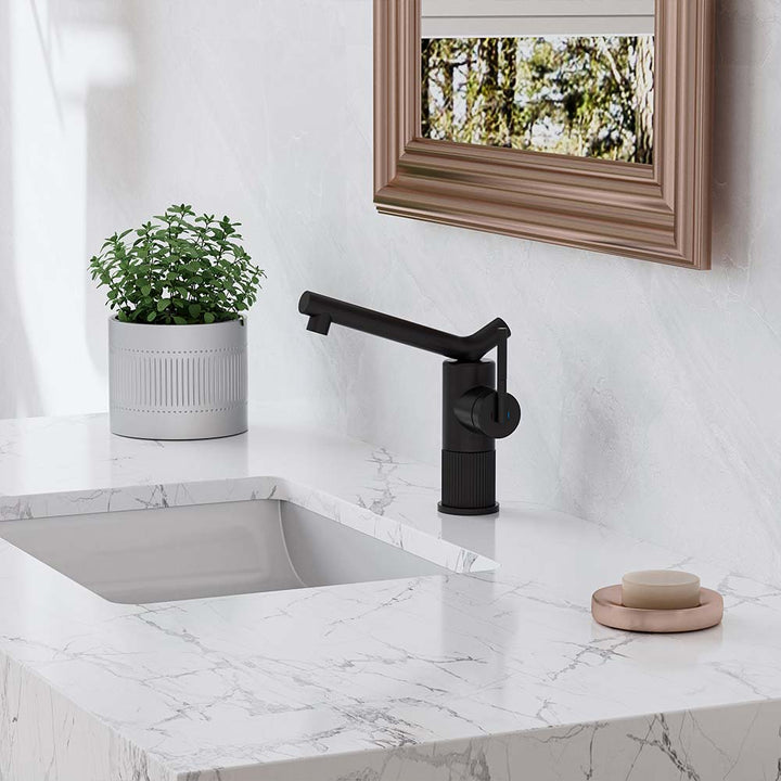 Modern black bathroom faucet on white marble vanity top