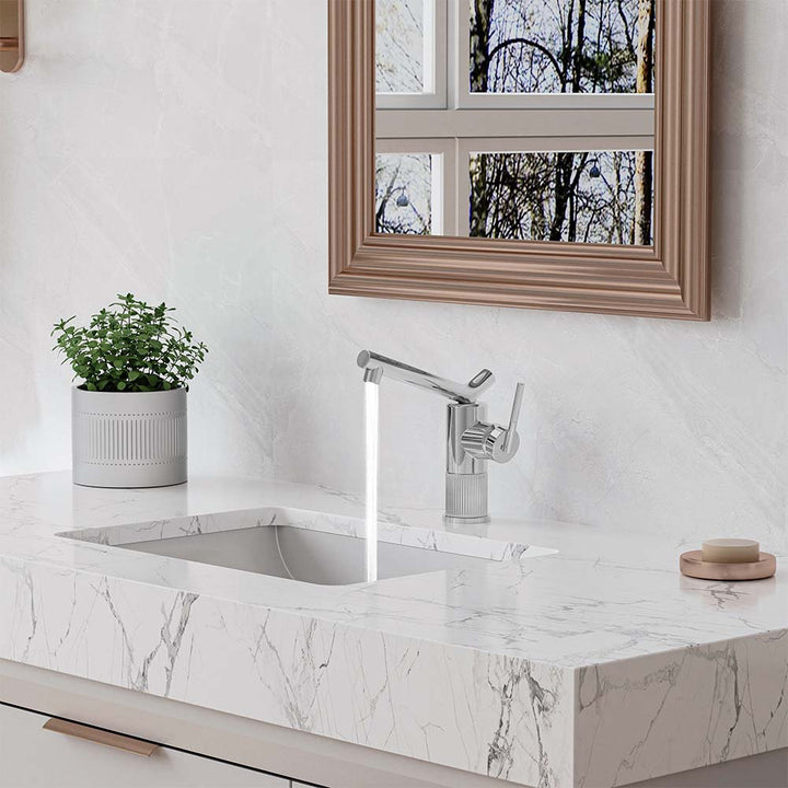 Chrome bathroom faucet installed on marble vanity sink
