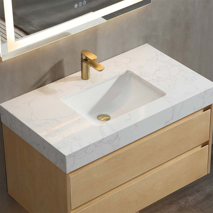 Modern floating vanity with white marble top and gold faucet
