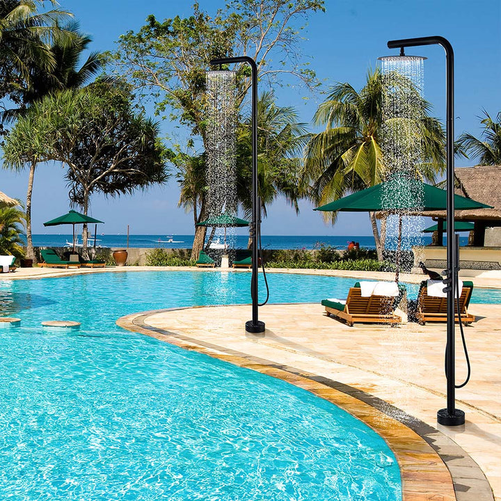 Black outdoor shower system in beach resort pool scene