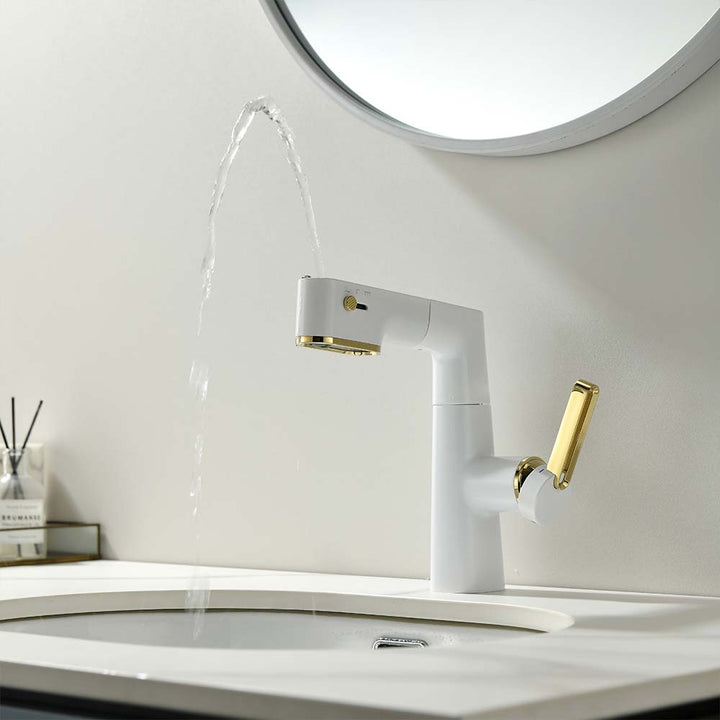 Modern white and gold bathroom faucet with water stream in a sink