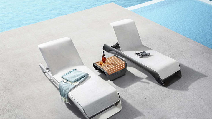 Outdoor lounger set with side table by pool, modern patio furniture for relaxing outdoors