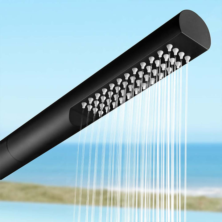 Close-up of black stainless steel outdoor shower head with water flowing