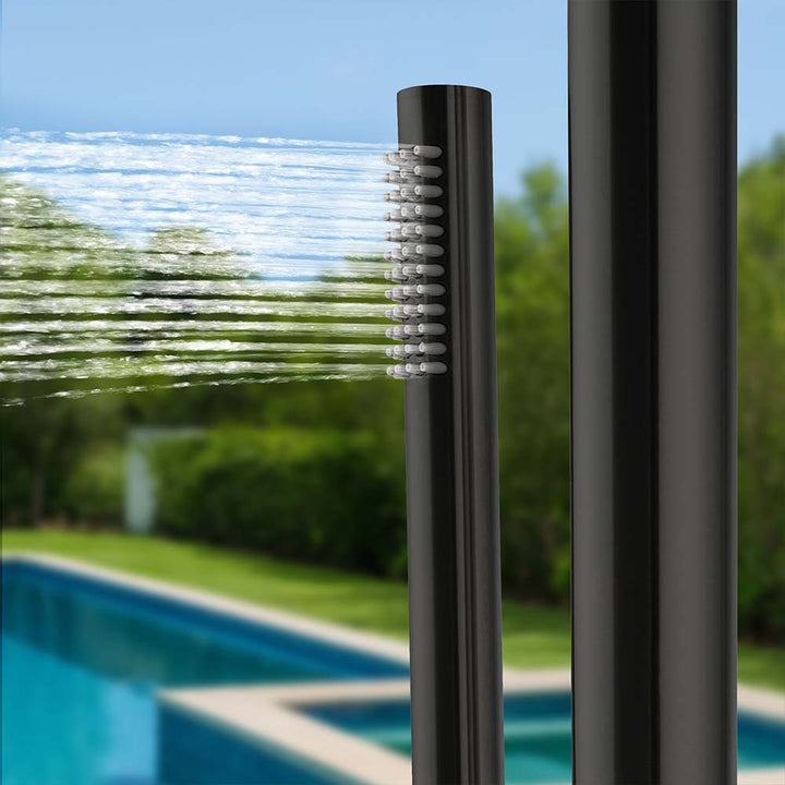 Close-up of the water spray from the black outdoor shower's side nozzle