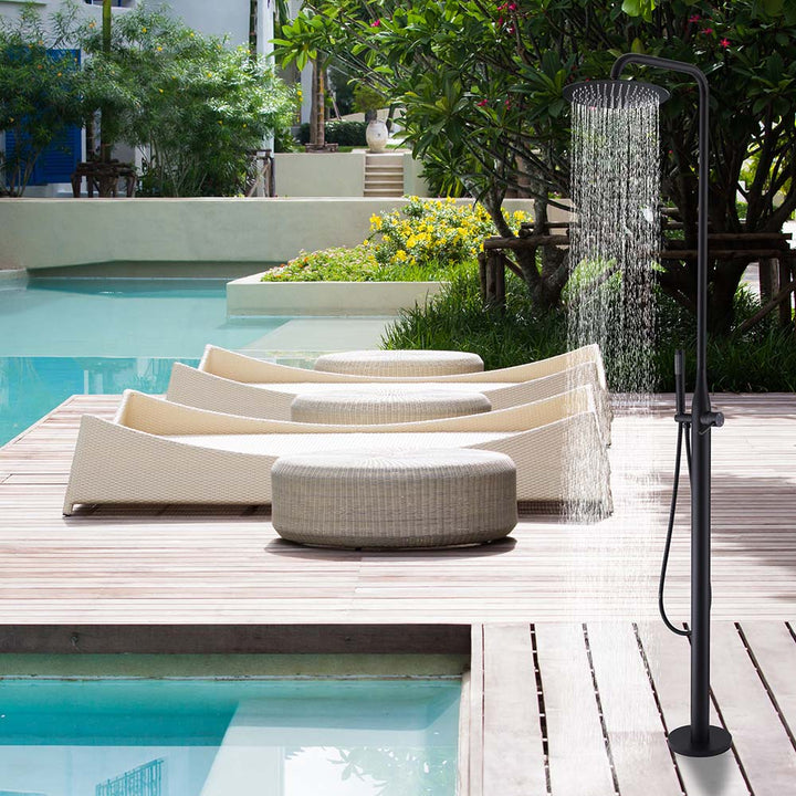 Outdoor shower system spraying water near poolside deck