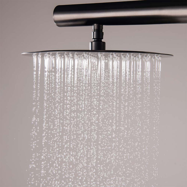 Close-up of black outdoor rainfall shower head in use