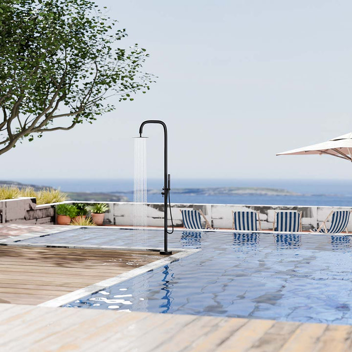 Black outdoor shower system in use by the pool