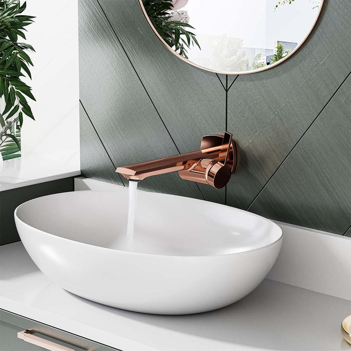 Rose gold faucet in use with water flowing into a white vessel sink.