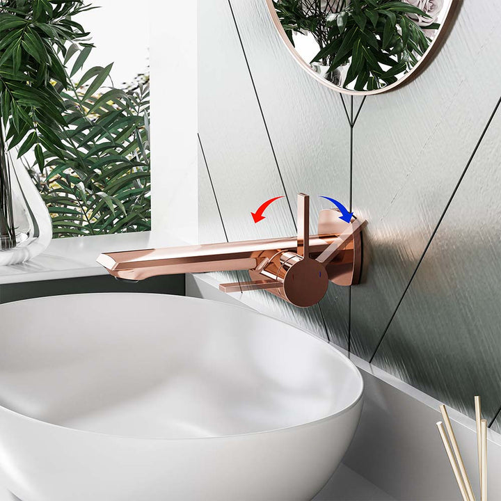 Rose gold faucet with hot and cold handle control on wall mount.