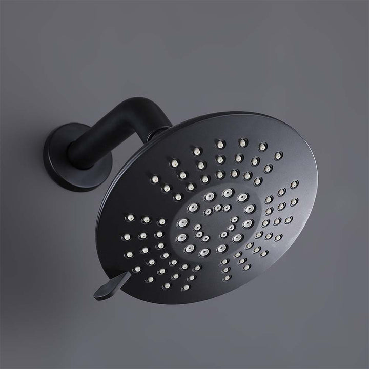 Close-up of round matte black multi-function shower head