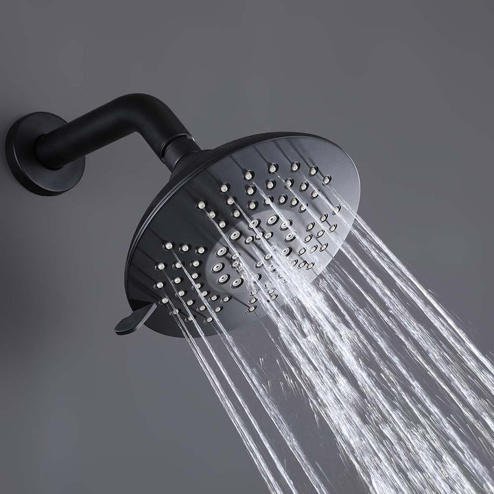 Matte black round shower head with water spray in action