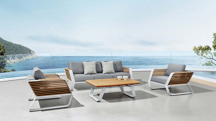 Modern aluminum and wood outdoor conversation set with gray cushions by the seaside view