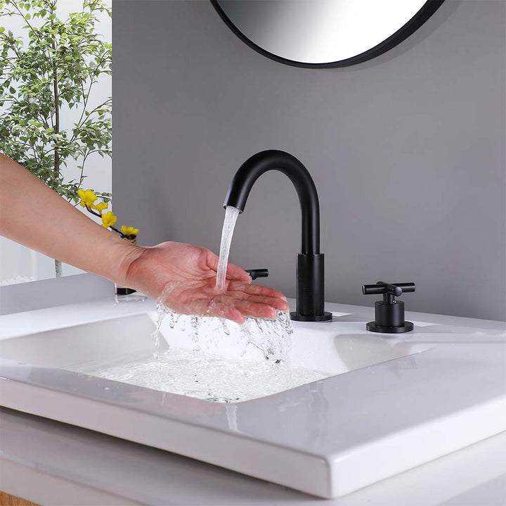 Modern black shower system faucet with water flowing into sink