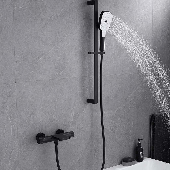 Black shower system handheld shower head spraying water on slide bar