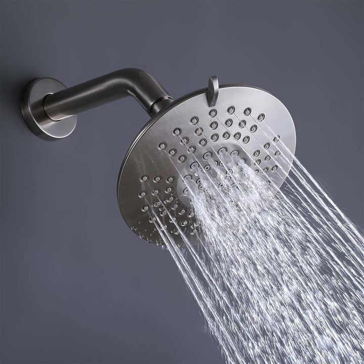 Brushed nickel shower system rain showerhead close up with water flow