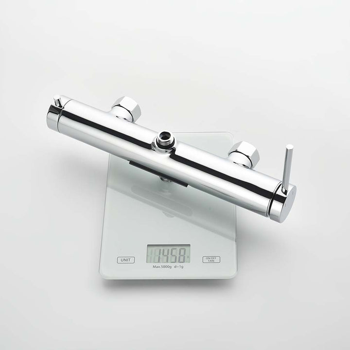 Chrome shower system valve body on scale showing weight 1456g
