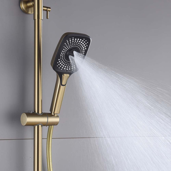 Brushed gold handheld shower spraying water from shower system.