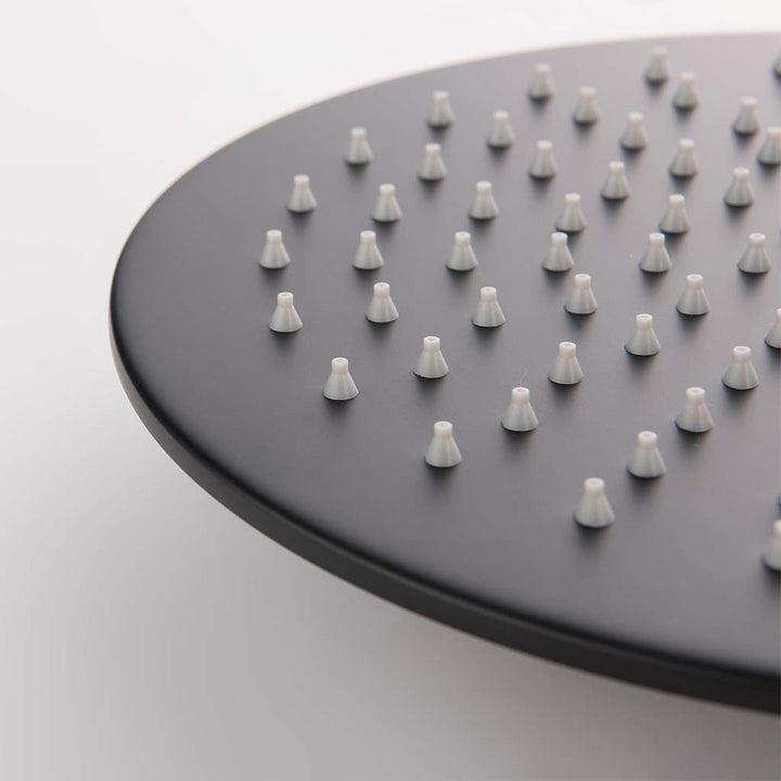 Round black rainfall shower system head close-up view