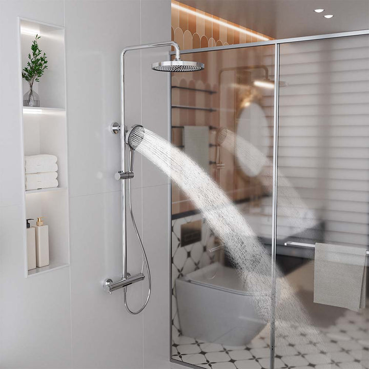 Silver shower system with handheld shower spray in bathroom