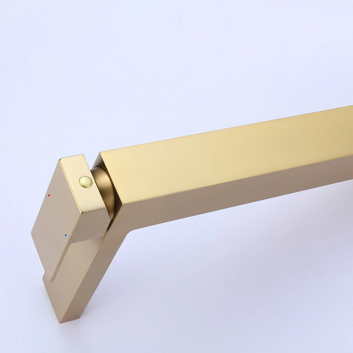 Gold single hole faucet handle detail showing modern square lever design
