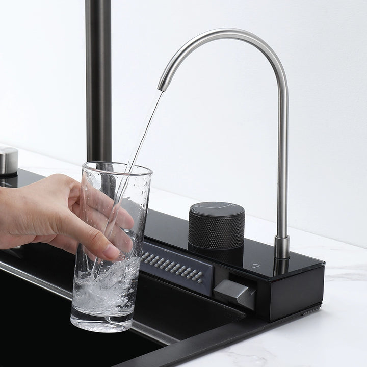 Smart kitchen sink water dispenser filling a glass with clean water