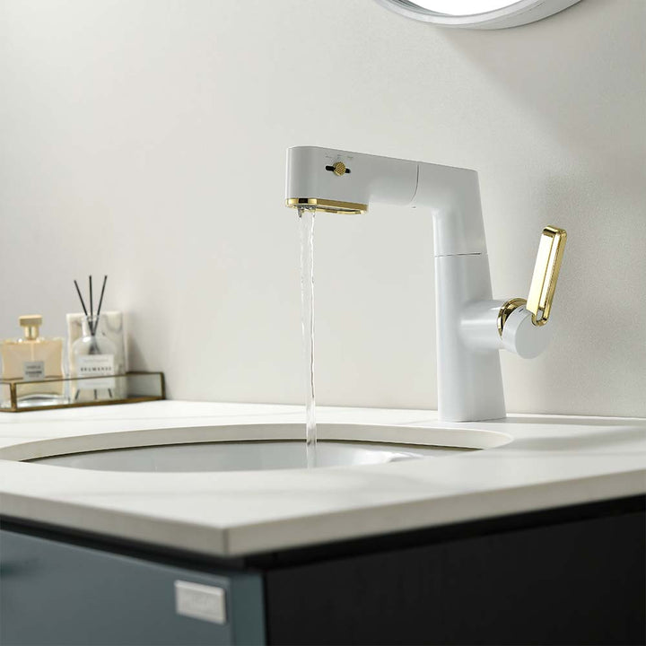 Modern white and gold bathroom faucet with flowing water in a stylish bathroom sink