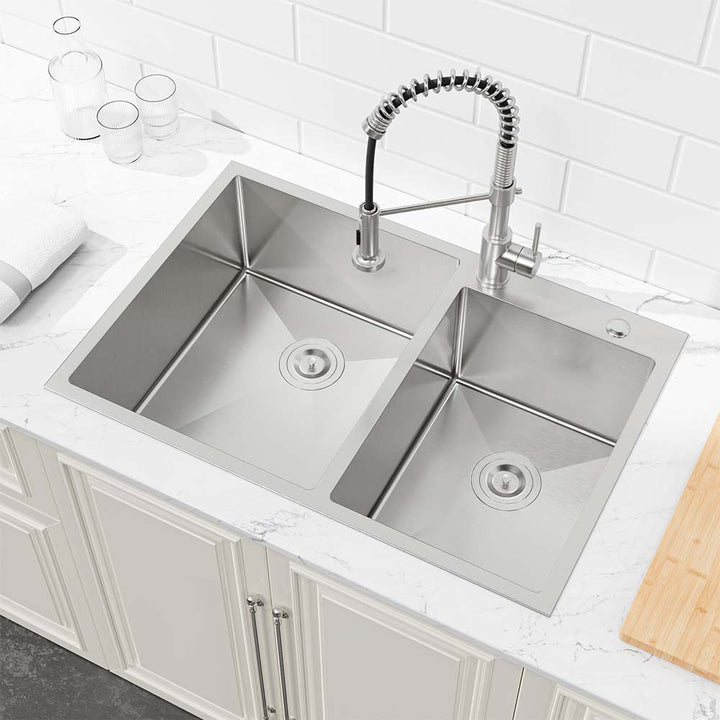 Topmount stainless steel double bowl kitchen sink installed in modern white cabinet kitchen with pull-down faucet