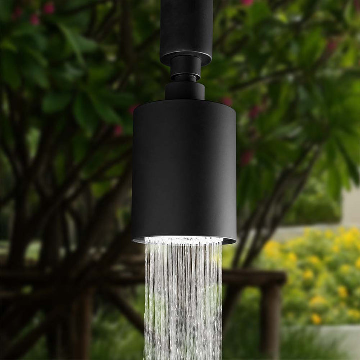 Close-up of outdoor shower head spraying water stream