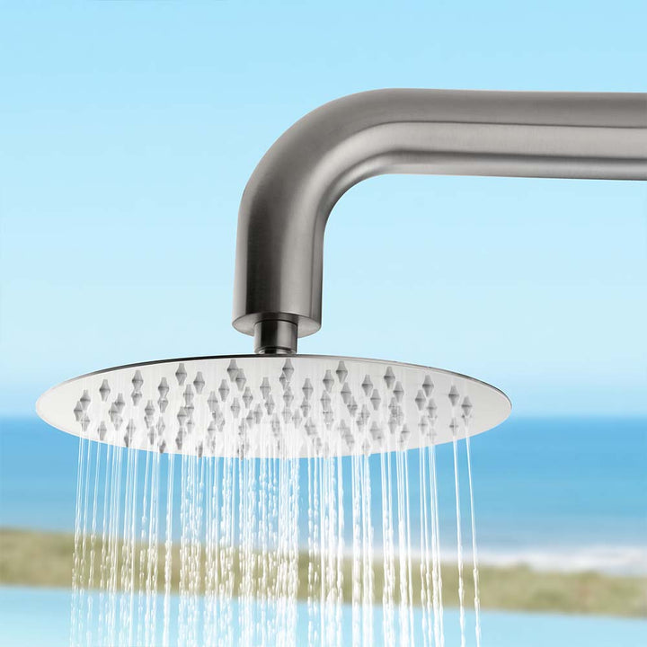 Stainless steel outdoor shower head detail with running water