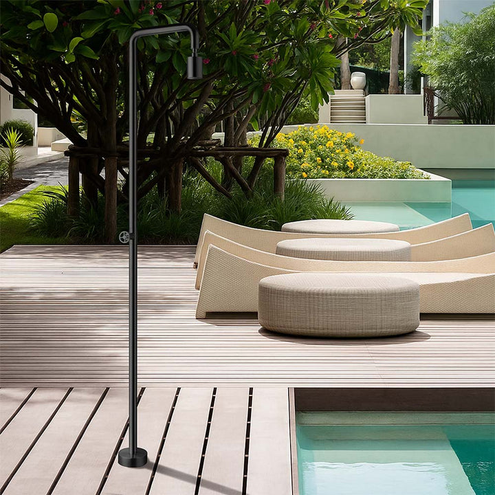 Stainless steel outdoor shower beside pool deck