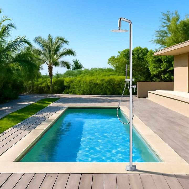 Stainless steel outdoor shower with overhead and handheld spray, poolside view