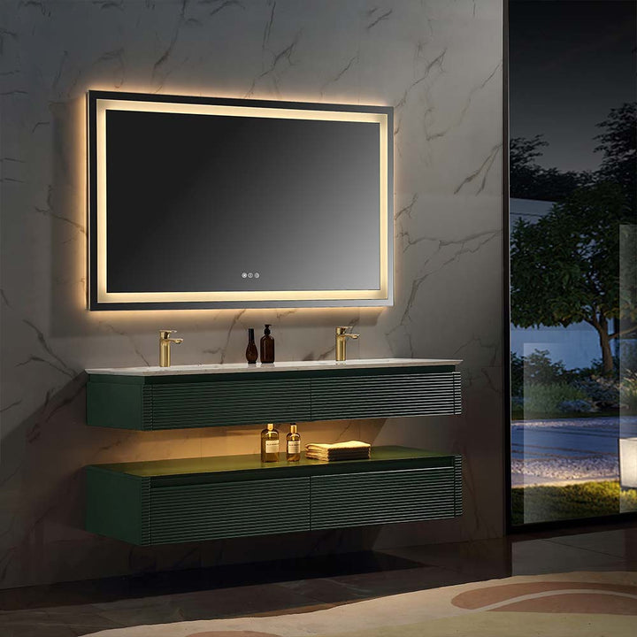 Wall mounted green bathroom vanity with LED mirror lighting at night