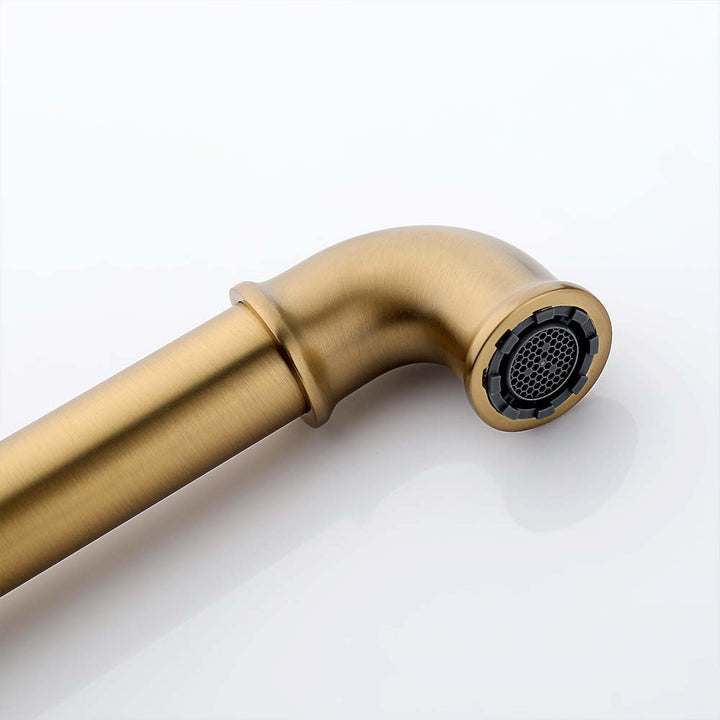 Close up of gold wall mounted bathroom faucet spout with aerator