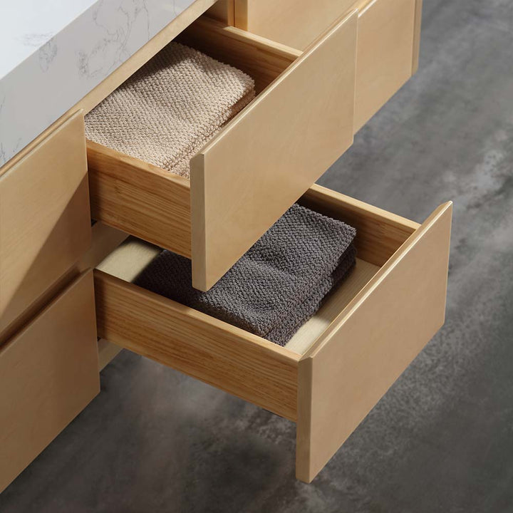 Wooden drawer with neatly organized towels in marble vanity